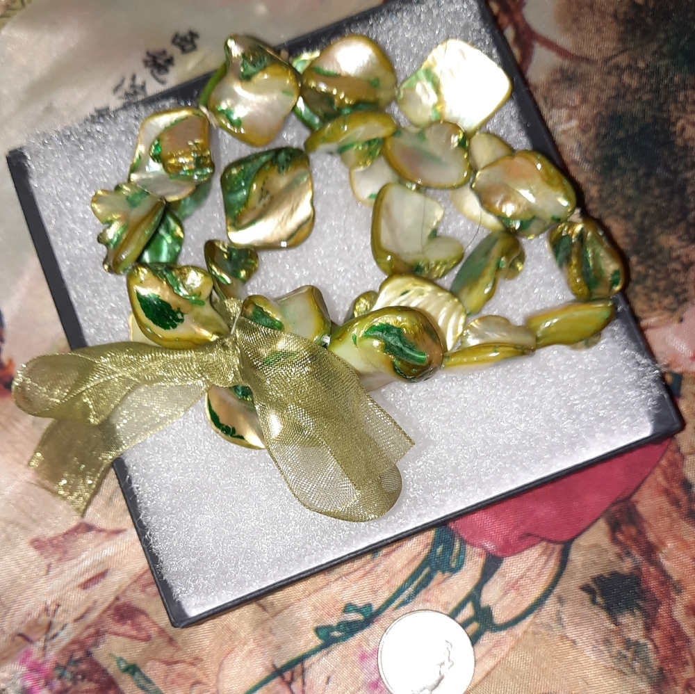 Multistrand nacre bead stretch bracelet with green ribbon bow